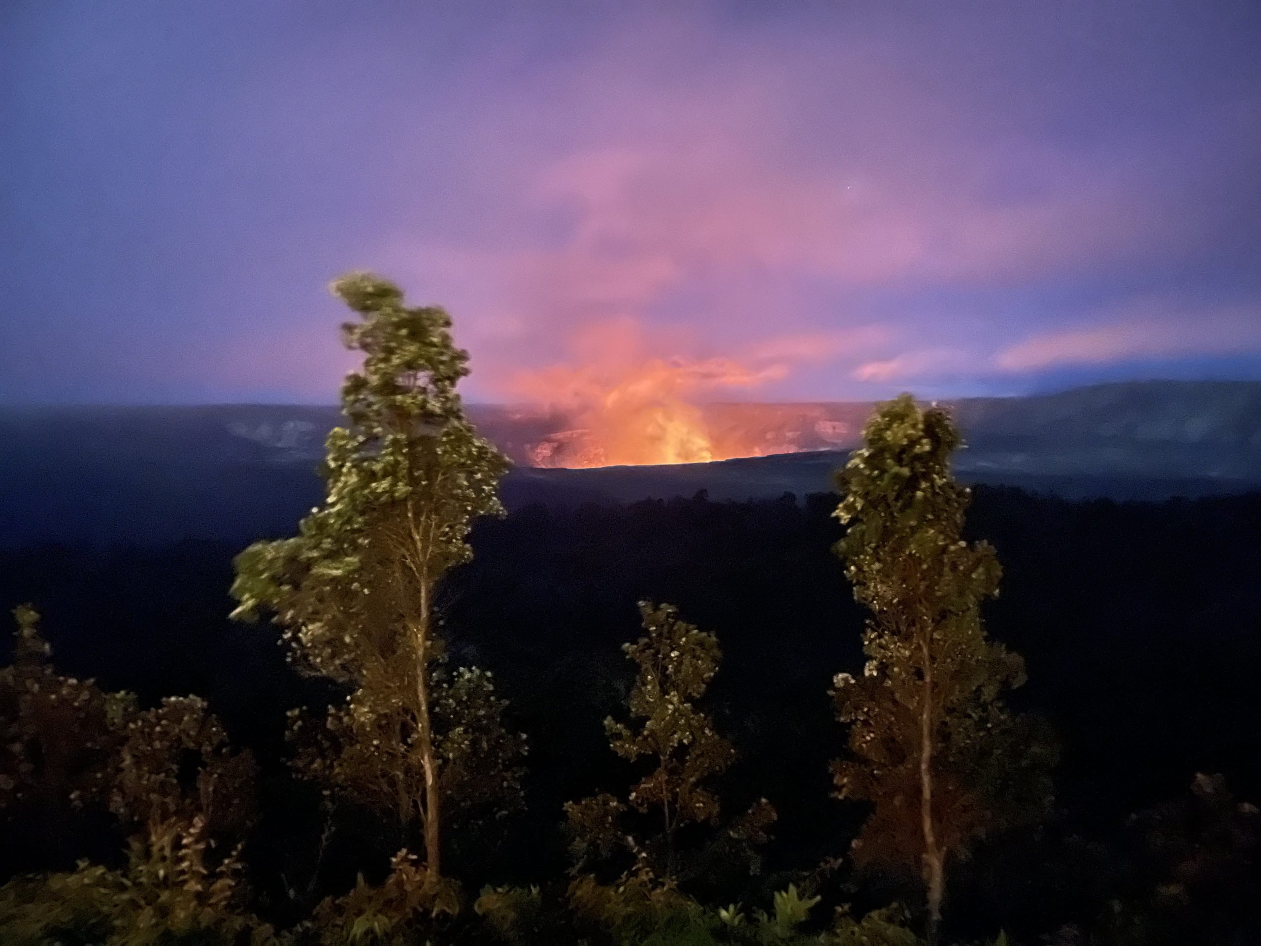 pele's fires and eruption activity are viewable in the distant crater on Hawaii island